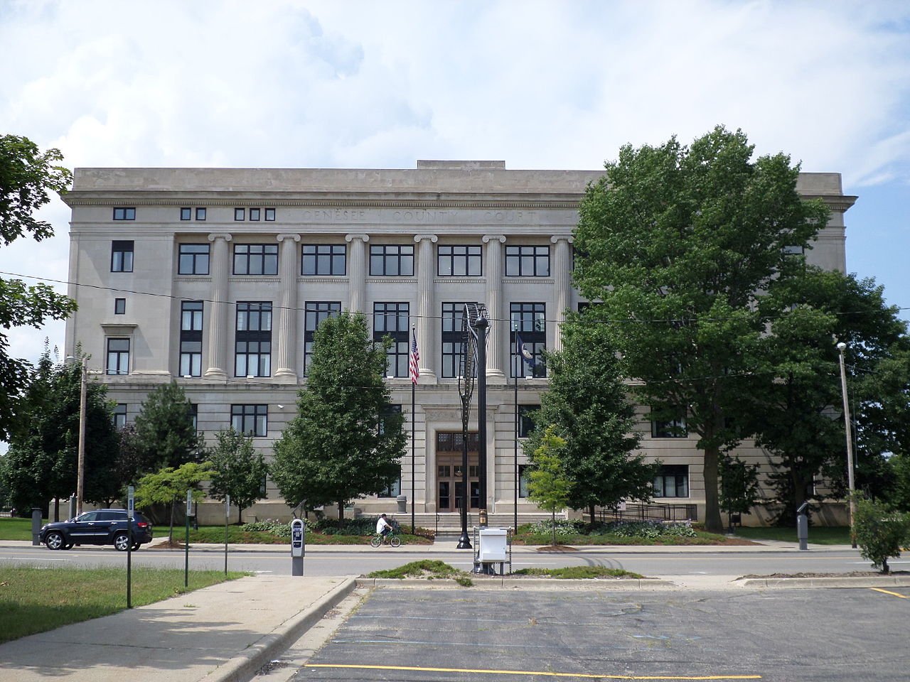 exterior of courthouse at end of street with trees in front of it