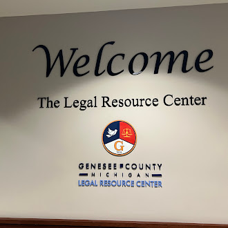 Wall of the Genesee Resource Center with 'Welcome' in large letters, and the Genesee county logo