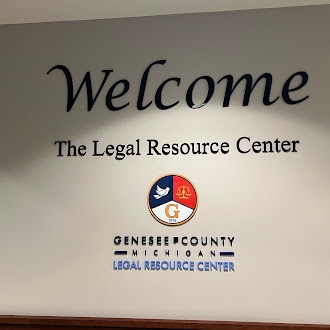 Wall of the Genesee Resource Center with 'Welcome' in large letters, and the Genesee county logo